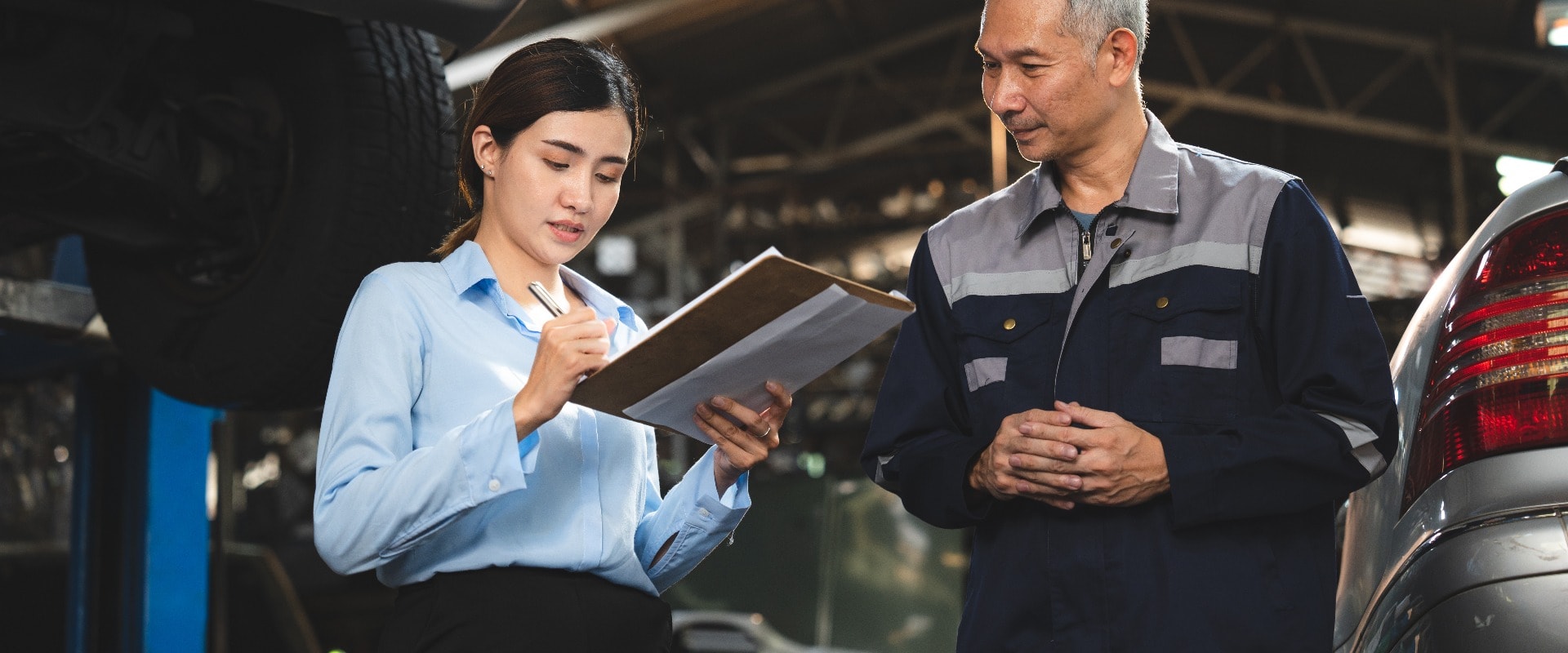 professional male technician mechanic man working to repair maintenance automobile at auto car garage service, talking with vehicle owner client about workshop job, automotive engine business shop